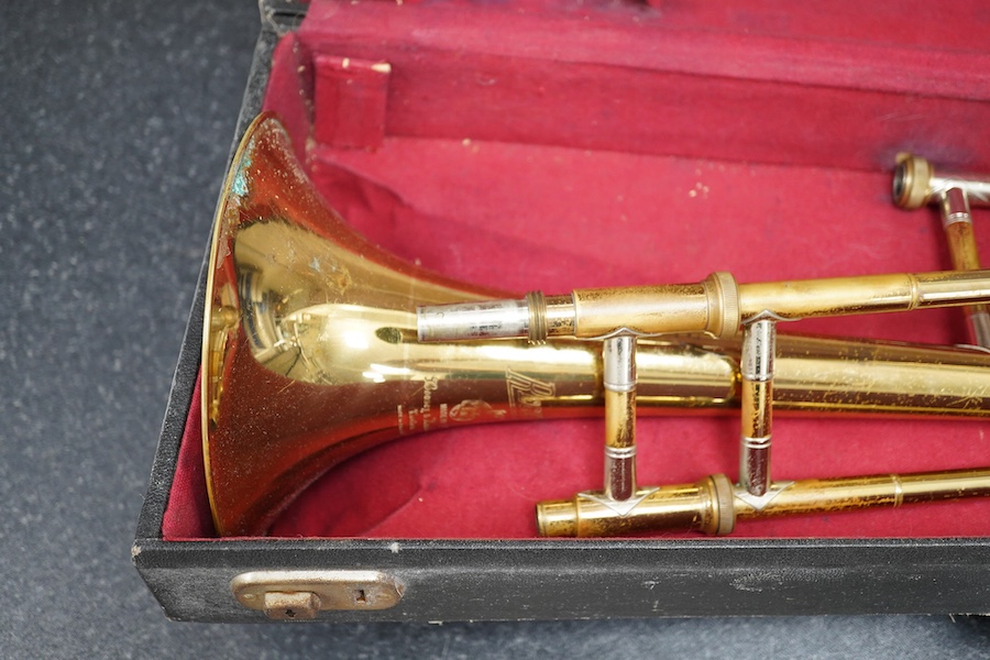 Three student trumpets by Beltone, etc. in soft cases and a cased Boosey & Hawkes trombone. Condition - poor to fair, all play